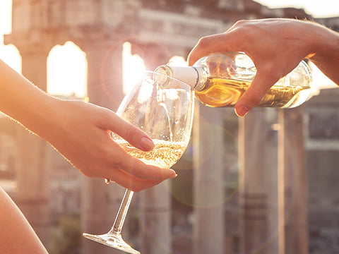 White wine glasses in an Italian landmark background