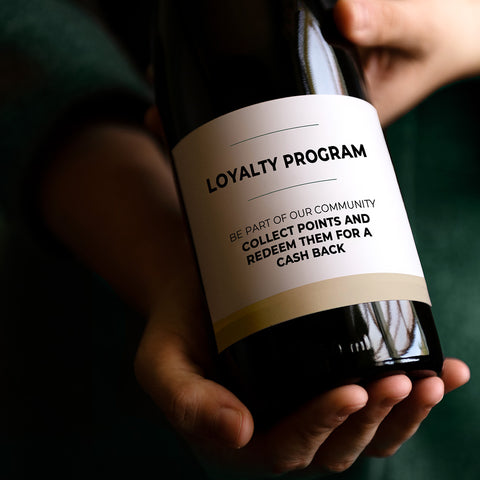 Bottle of wine with a loyalty program message written on the label 13C Jordan Amman